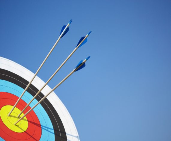 Archery target with arrows in the bull's eye